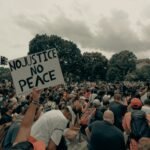 a large crowd of people holding up signs